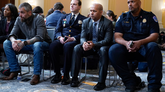 FILE - From left, Serena Liebengood, widow of U.S. Capitol Police officer Howie Liebengood, former Washington Metropolitan Police Department officer Michael Fanone Washington Metropolitan Police Department officer Daniel Hodges, U.S. Capitol Police Sgt. Aquilino Gonell and U.S. Capitol Police Sgt. Harry Dunn listen as the House select committee investigating the Jan. 6 attack on the U.S. Capitol holds a hearing on Capitol Hill in Washington, Oct. 13, 2022. (AP Photo/Jacquelyn Martin, File)