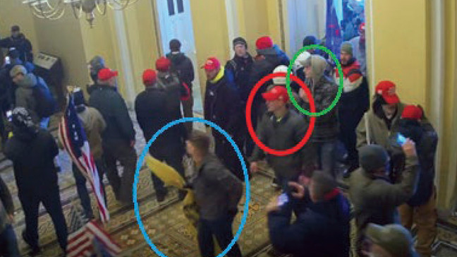 FILE - In this image from U.S. Capitol Police video, released and annotated by the Justice Department in the Statement of Facts supporting an arrest warrant, Joshua Abate, circled in green, Micah Coomer, circled in red, and Dodge Dale Hellonen, circled in blue, appear inside the U.S. Capitol on Jan. 6, 2021, in Washington. Hellonen, one of three active-duty Marines who stormed the U.S. Capitol together, has been sentenced to probation instead of prison time. U.S. District Judge Ana Reyes also on Monday, Sept. 11, 2023, ordered Hellonen to perform 279 hours of community service. (Justice Department via AP, File)