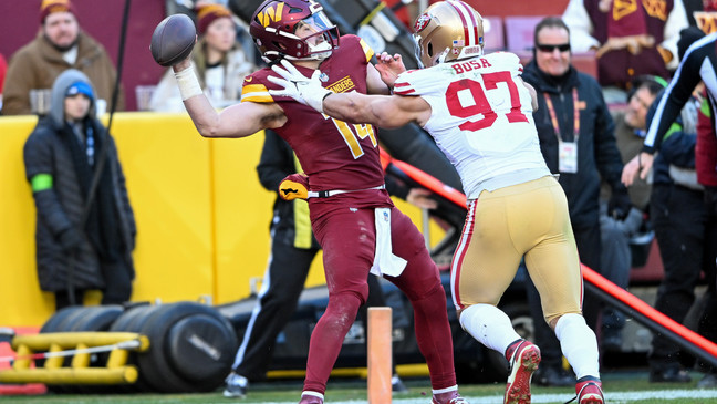LANDOVER, MARYLAND - DECEMBER 31: Sam Howell #14 of the Washington Commanders throws a pass in front of Nick Bosa #97 of the San Francisco 49ers during the fourth quarter at FedExField on December 31, 2023 in Landover, Maryland. (Photo by Greg Fiume/Getty Images)