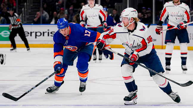 New York Islanders left wing Matt Martin (17) pursues as Washington Capitals defenseman Rasmus Sandin (38) looks to pass during the second period of an NHL hockey game in Elmont, N.Y., Friday, Dec. 29, 2023. (AP Photo/Peter K. Afriyie)