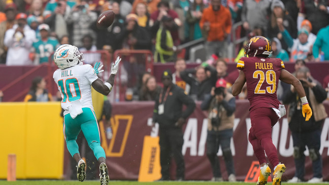Miami Dolphins wide receiver Tyreek Hill (10) catches a touchdown pass in front of Washington Commanders cornerback Kendall Fuller (29) during the first half of an NFL football game Sunday, Dec. 3, 2023, in Landover, Md. (AP Photo/Alex Brandon)