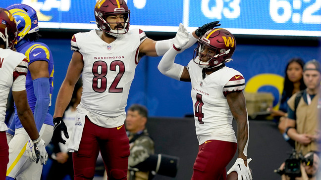 Washington Commanders tight end Logan Thomas (82) celebrates with wide receiver Curtis Samuel (4) after Samuel scored a touchdown during the second half of an NFL football game Los Angeles Rams Sunday, Dec. 17, 2023, in Los Angeles. (AP Photo/Ryan Sun)